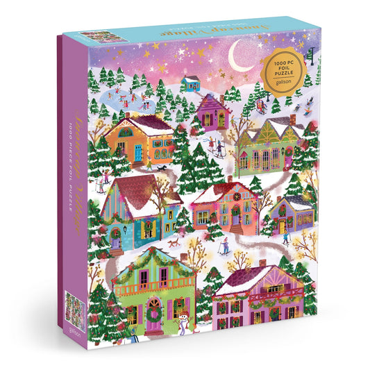 The Joy Laforme Snowcap Village 1000 Piece Foil Puzzle features a festive winter village with snow-covered houses, decorated trees, ice skaters, and a starry night sky with a crescent moon.
