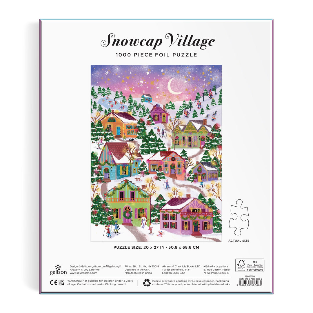 The back of the Joy Laforme Snowcap Village 1000 Piece Foil Puzzle box shows a vibrant winter village with snow-covered houses, skaters, and a starry sky, highlighting stunning foil details from the Joy Laforme brand.