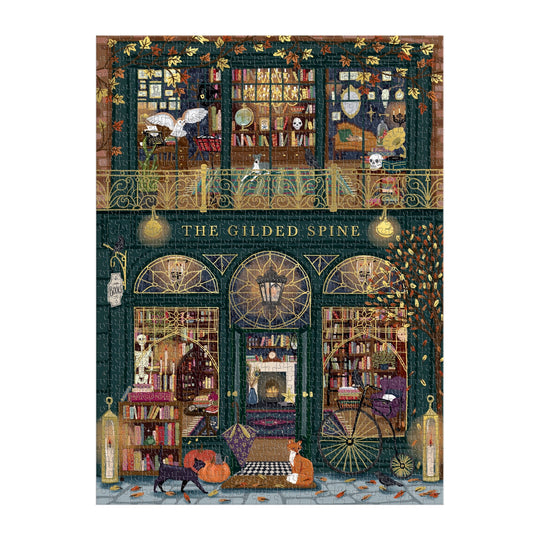 Sally Wilson’s The Gilded Spine 1000 Piece Foil Puzzle features a cozy two-floor bookshop filled with books, glowing lights, autumn leaves, and lounging cats in a warm, inviting scene with golden foil accents and intricate details.