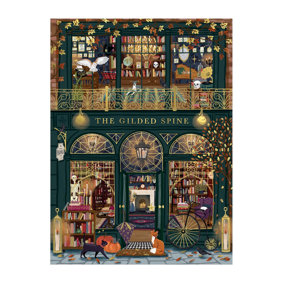 Experience Sally Wilson’s The Gilded Spine 1000 Piece Foil Puzzle, featuring a whimsical bookstore with two book-filled floors, arched windows, golden accents, fall leaves, and cozy autumn vibes—plus charming cats outside.