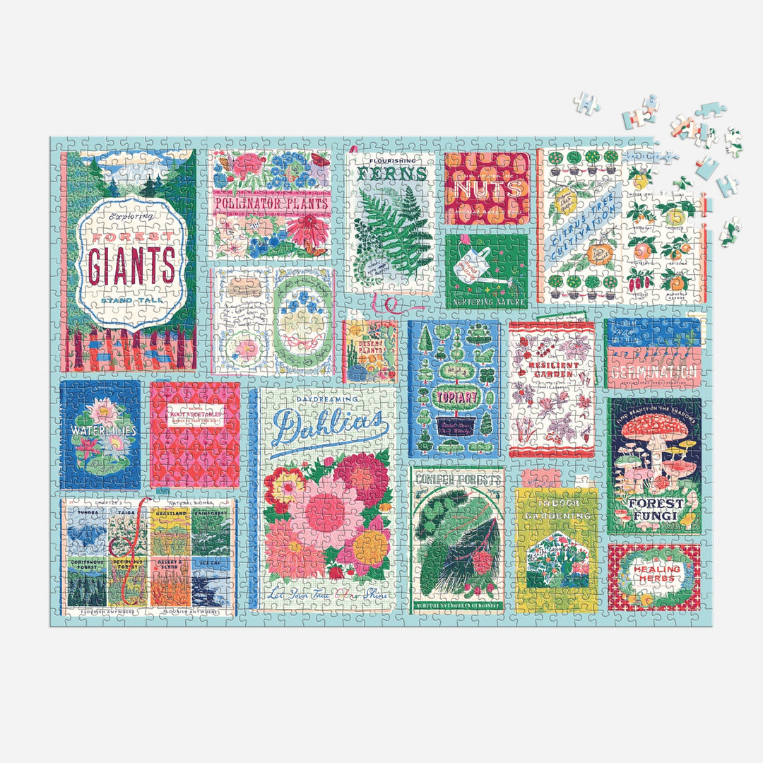 The Ever Upward Botanist Bookshelf 1000 Piece Puzzle by Emily Taylor shows vibrant vintage botanical book covers—flowers, ferns, mushrooms, and plants—with a few pieces left to finish in the upper right corner.