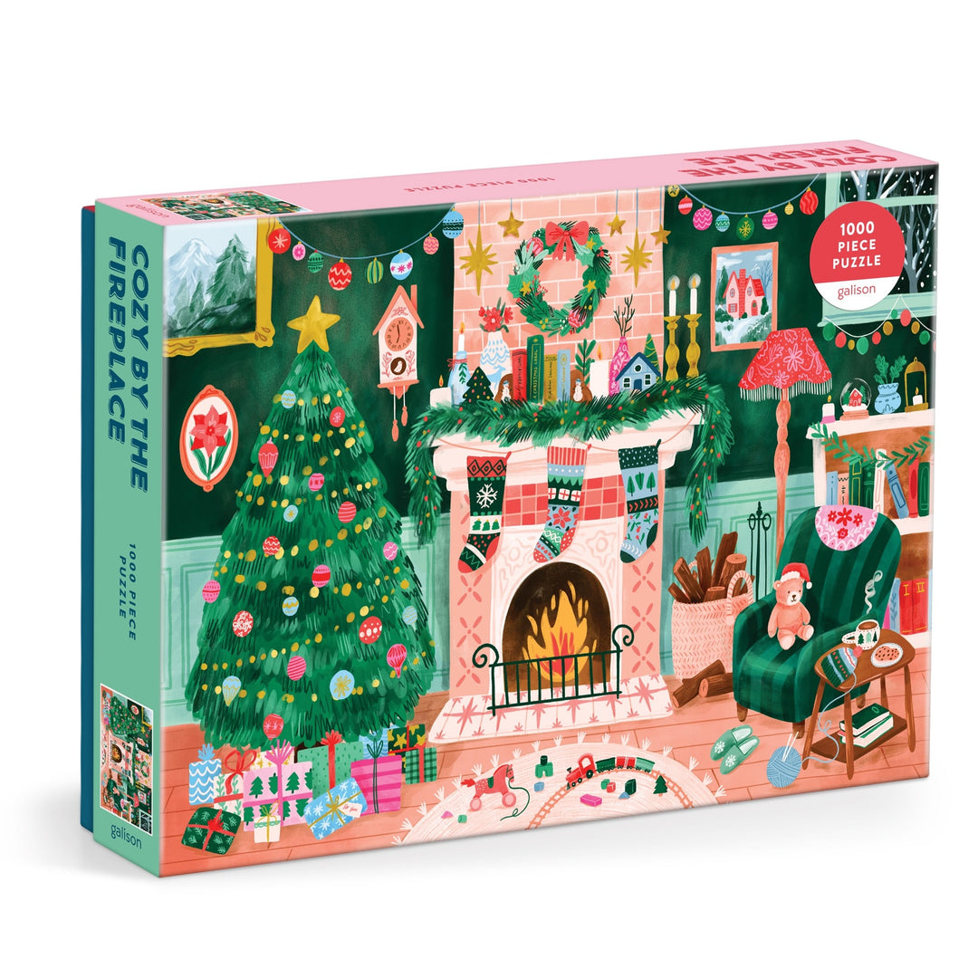 Cozy by the Fireplace 1000 Piece Puzzle by Carla Ellis features a festive Christmas scene with a decorated tree, gifts, stockings on a glowing fireplace, and comfy chairs—perfect for puzzle lovers seeking holiday cheer.