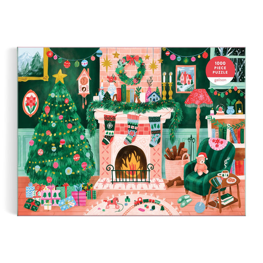 Enjoy Carla Ellis’s Cozy by the Fireplace 1000 Piece Puzzle—a charming Christmas scene featuring gifts, stockings, wreath, candles, bookshelves, and a green armchair with a teddy bear and cup—perfect for puzzle fans.
