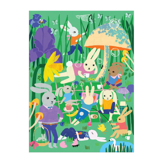 Experience a lively, whimsical scene with the Bunny Daydream 1000 Piece Puzzle by Anne Bentley—rabbits play, read, picnic, and blow bubbles among flowers and mushrooms in a colorful grassy field.