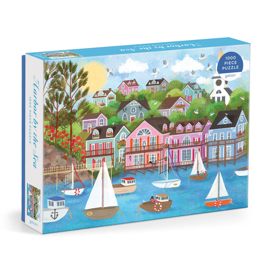 The Joy Laforme Harbor by the Sea 1000 Piece Puzzle by Joy Laforme features a vibrant Nantucket-inspired seaside town, with boats, colorful houses, trees, flowers, and birds soaring above blue water.