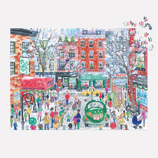 The Michael Storrings Christmas in Greenwich Village 1000 Piece Puzzle by Michael Storrings features a vibrant city street with jazz clubs, a pastry shop, bookstores, vintage cars, and festive musicians—some pieces remain unfinished in the top right corner.