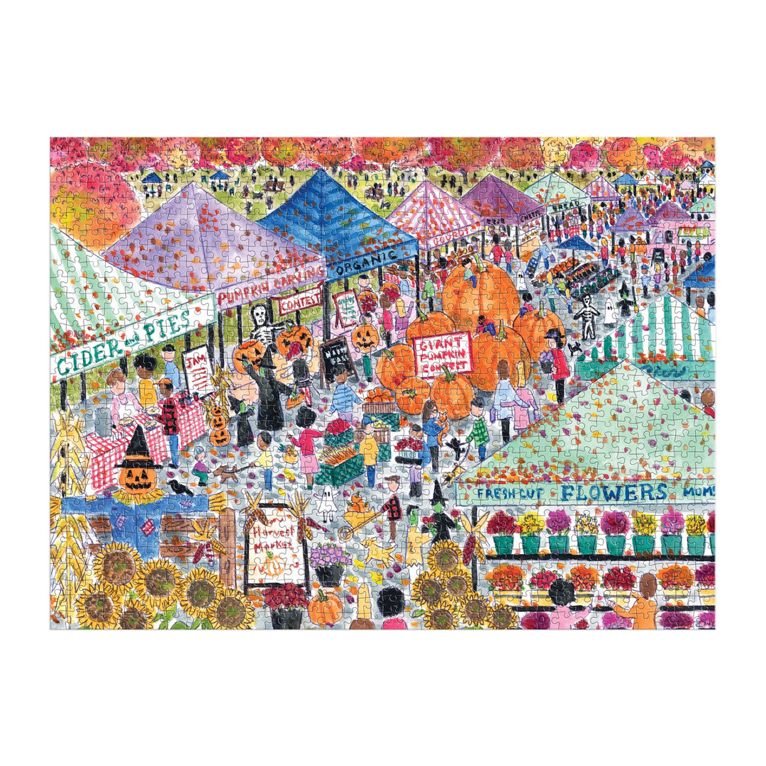 The Michael Storrings Harvest Market 1000 Piece Puzzle by Michael Storrings features a vibrant autumn festival scene with tents selling pies, flowers, organic produce, costumes, pumpkins, festive signs, and fall foliage.
