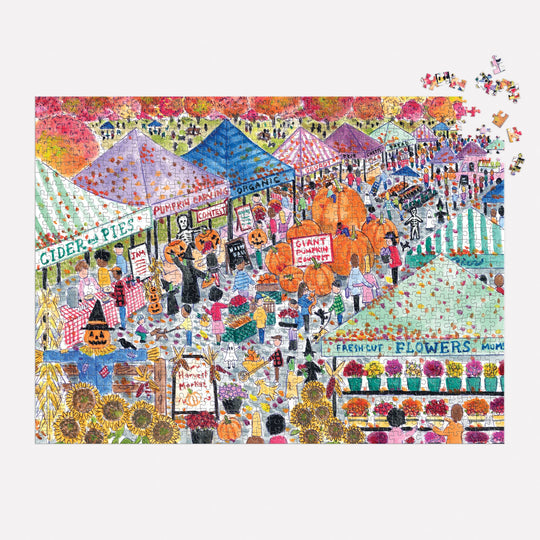 Michael Storrings Harvest Market 1000 Piece Puzzle by Michael Storrings features a vibrant fall festival scene with striped tents offering cider, pies, organic produce, flowers, pumpkins, and costumed visitors. Puzzle pieces shown in the top right corner.