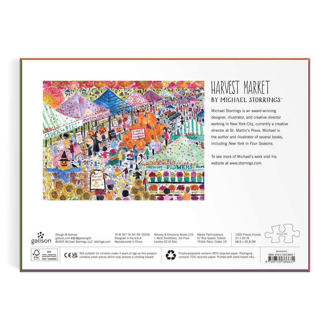 The back of the Michael Storrings Harvest Market 1000 Piece Puzzle box features a vibrant scene with tents, flowers, shoppers, and autumn decor, plus text about the artwork and artist Michael Storrings.