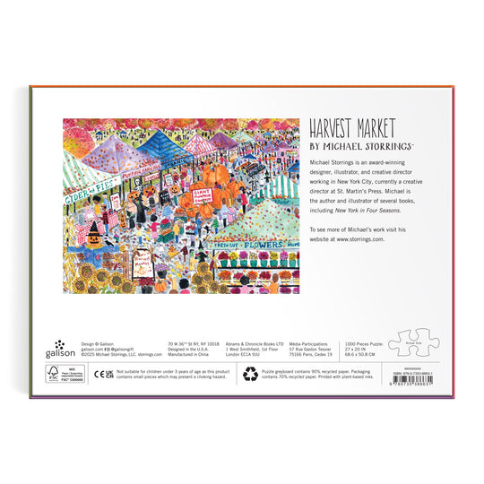 The back of the Michael Storrings Harvest Market 1000 Piece Puzzle box features a vibrant scene with tents, flowers, shoppers, and autumn decor, plus text about the artwork and artist Michael Storrings.