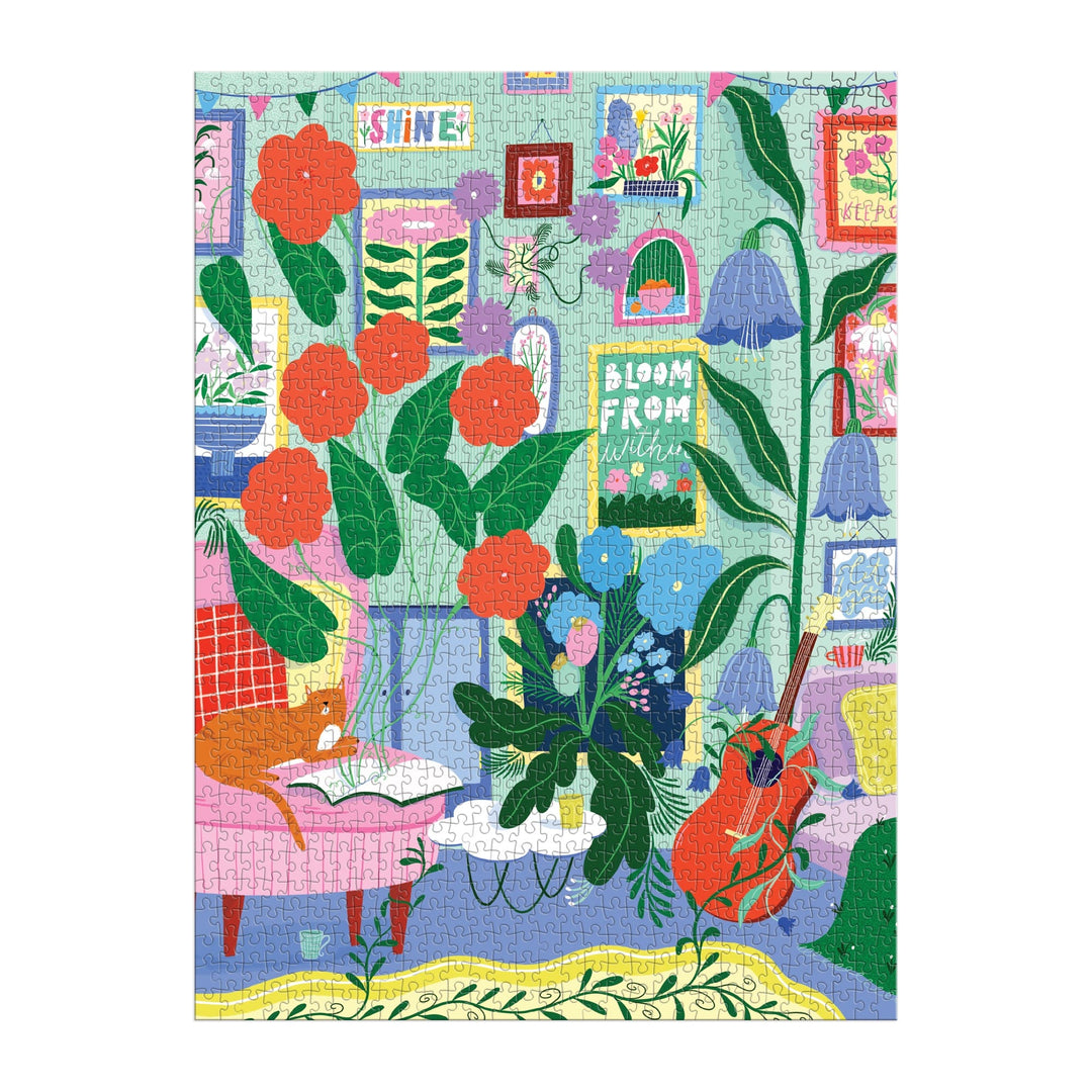 The Room to Bloom 1000 Piece Puzzle by Jessica Smith features a cozy indoor scene with vibrant flowers, leafy plants, framed art, bookshelves, a red chair, guitar, and a “Bloom From Within” sign against pastel walls.