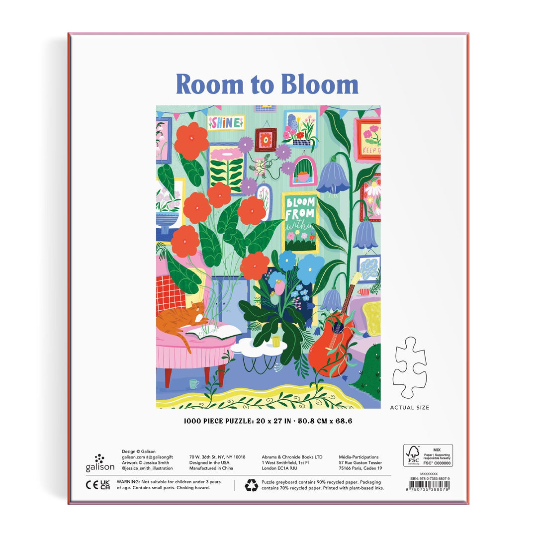 The image shows the back of the Jessica Smith Room to Bloom 1000 Piece Puzzle box with a colorful scene of a cozy room filled with leafy plants, red flowers, bookshelves, art, and a black cat on a yellow chair.