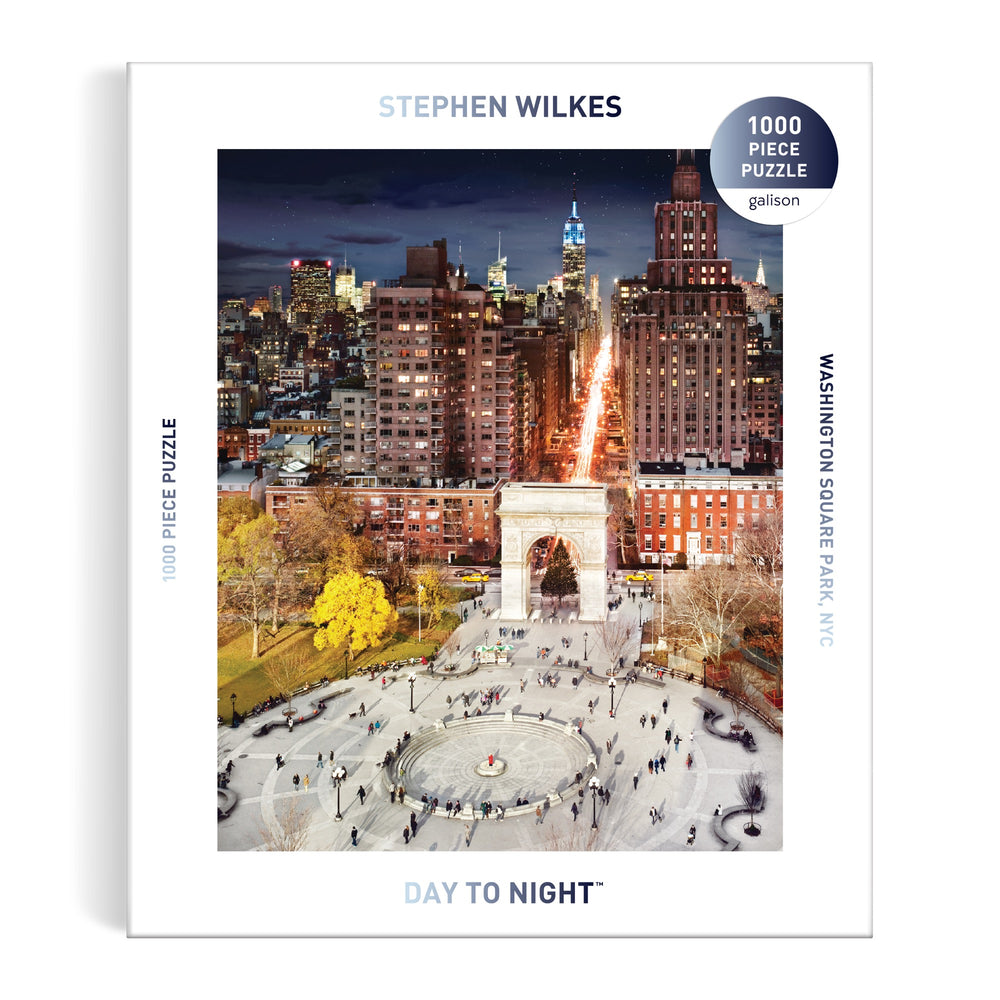 The Stephen Wilkes Day To Night Washington Square Park 1000 Piece Puzzle features an iconic image of the park and arch transitioning from day to night, framed by NYC city buildings. Brand: Stephen Wilkes.
