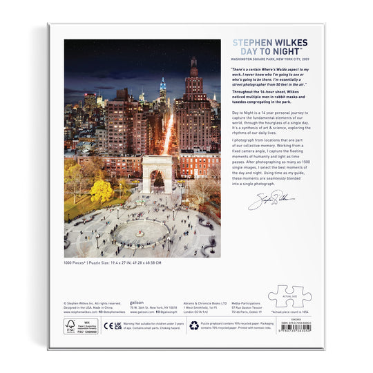 The image shows the back of the Stephen Wilkes Day To Night Washington Square Park 1000 Piece Puzzle box, featuring Wilkes iconic NYC park photo blending day and night, with crowds, city buildings, and puzzle details on the box.
