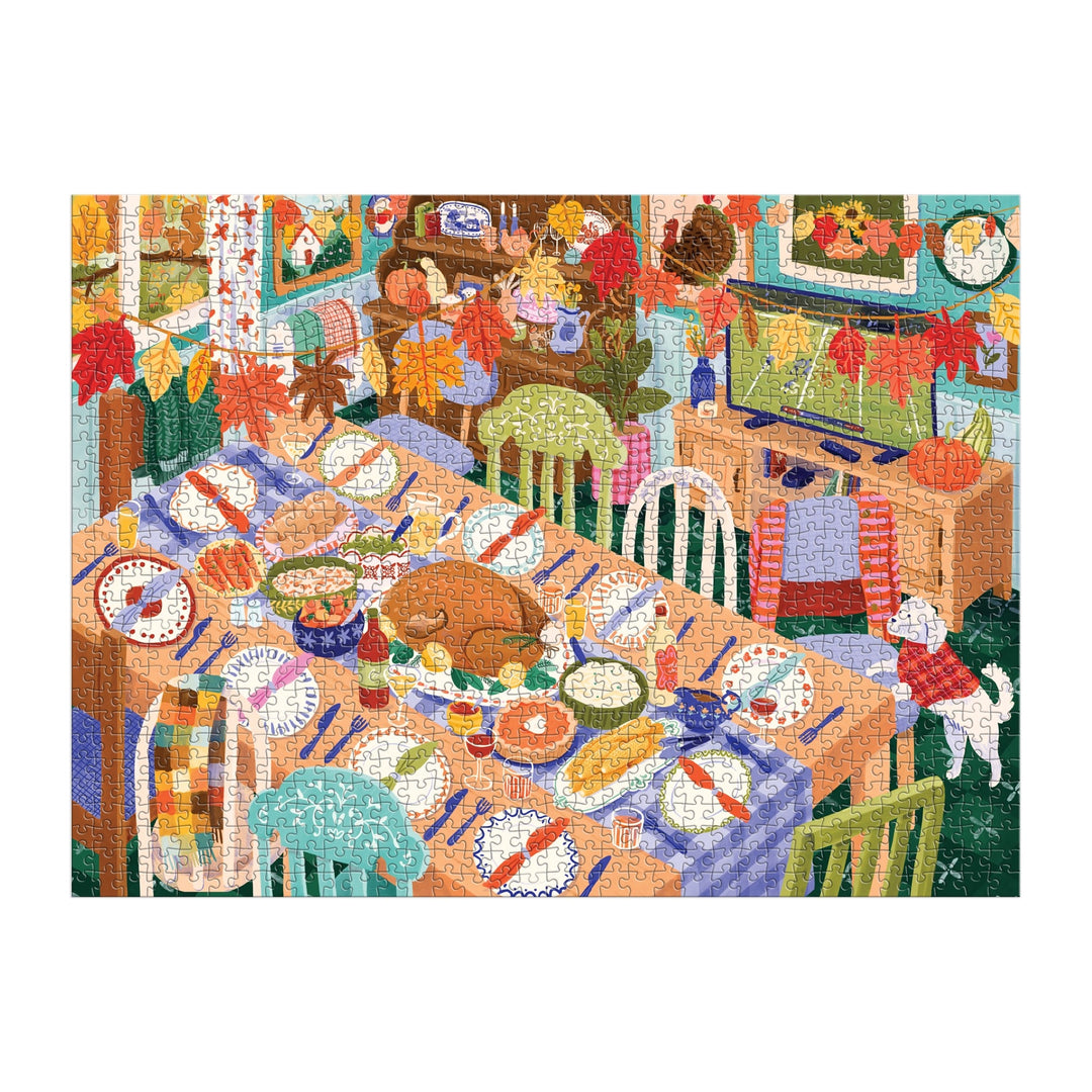 The Carla Ellis Thankful Table 1000 Piece Puzzle features a festive dining room set for Thanksgiving with autumn décor, delicious dishes, a dog on the floor, and a family preparing to enjoy their meal.