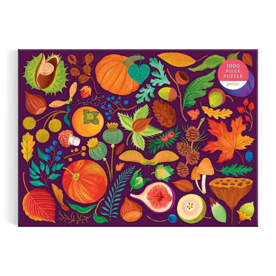 The World of Fall Flora 1000 Piece Puzzle by Dawn Cooper features a vibrant autumn design with illustrated pumpkins, mushrooms, leaves, berries, pinecones, acorns, and more on a dark purple box.
