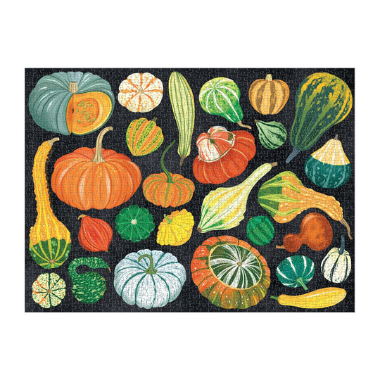The World of Pumpkins 1000 Piece Puzzle by Dawn Cooper features a vibrant array of squash and gourds in unique shapes, sizes, and colors, beautifully arranged against a striking black background.