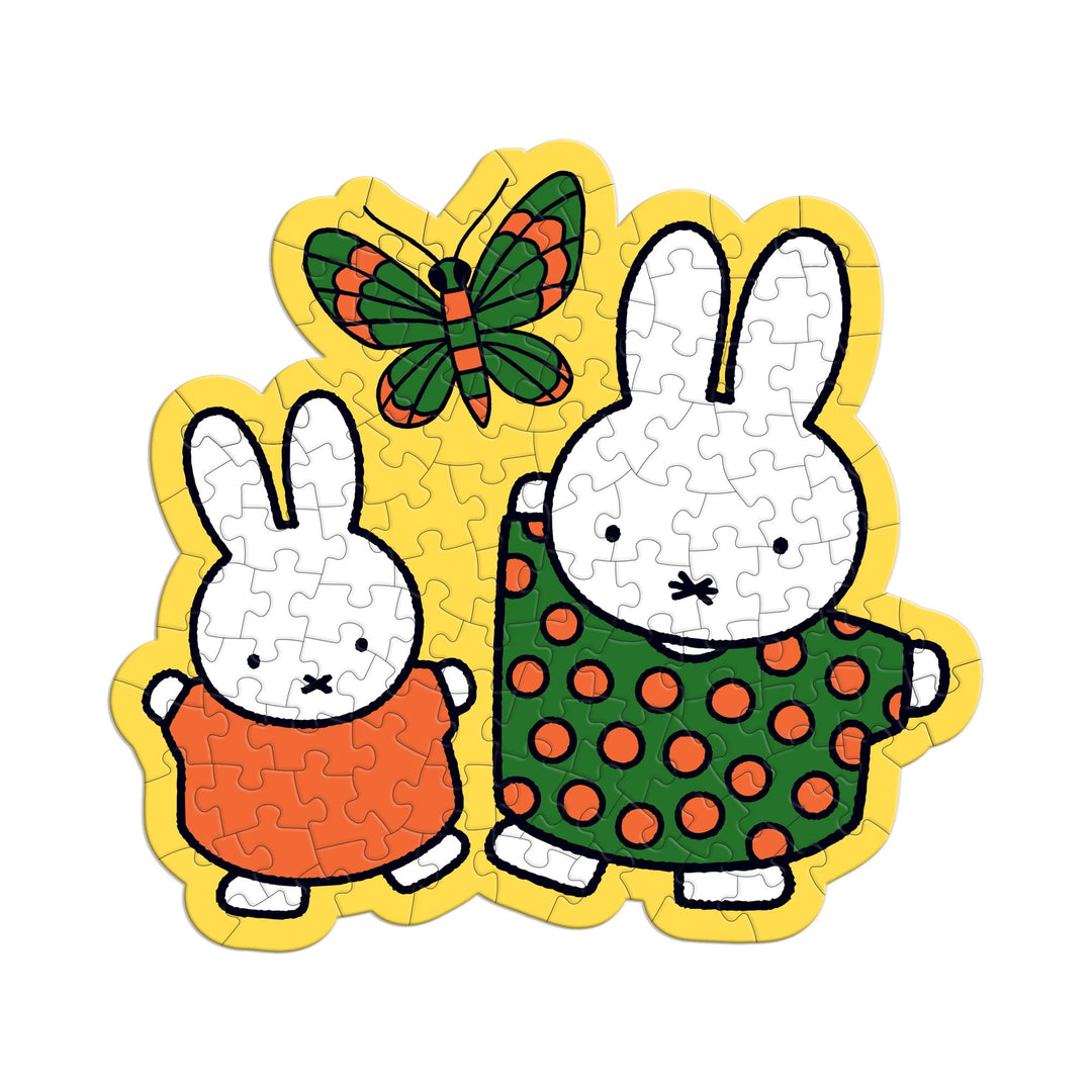The Miffy 100 Piece Surprise Puzzle by Miffy features two cartoon white rabbits in colorful polka-dot and solid dresses, with green, red, and yellow butterflies above them on a bright yellow background.