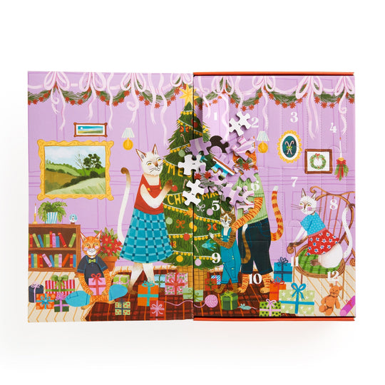 Joanna Letz’s Meowy Christmas 12 Days of Puzzles 500 Piece Countdown features festive cats decorating a tree and exchanging gifts in a cozy room, with numbered doors and puzzle pieces—ideal for cat lovers and advent calendar fun.