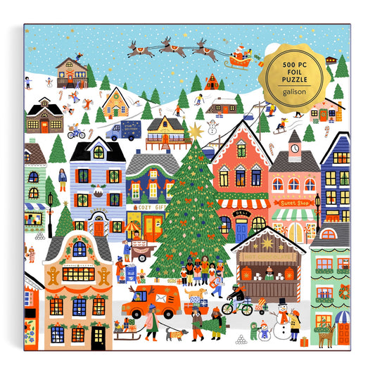 A festive winter village scene by Holly Maguire features colorful houses, people ice skating, gift giving, a big Christmas tree, and Santa flying overhead. "Merryville 500 Piece Foil Puzzle" is displayed in the top right corner.
