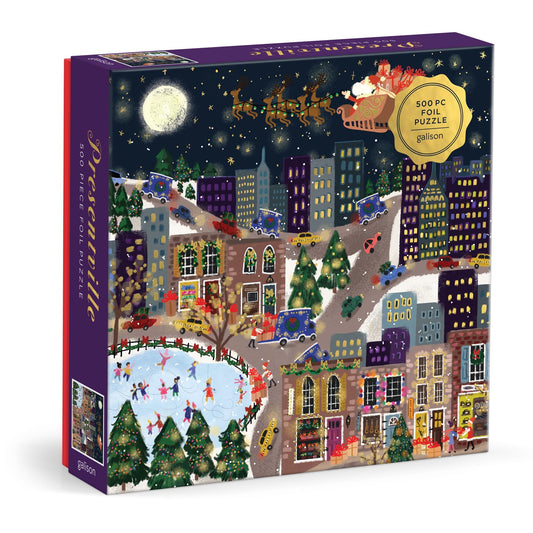 The Joy Laforme Presentville 500 Piece Foil Puzzle features a festive cityscape with people ice skating, decorated buildings, Christmas trees, and Santa’s sleigh flying over snowy rooftops beneath a full moon.