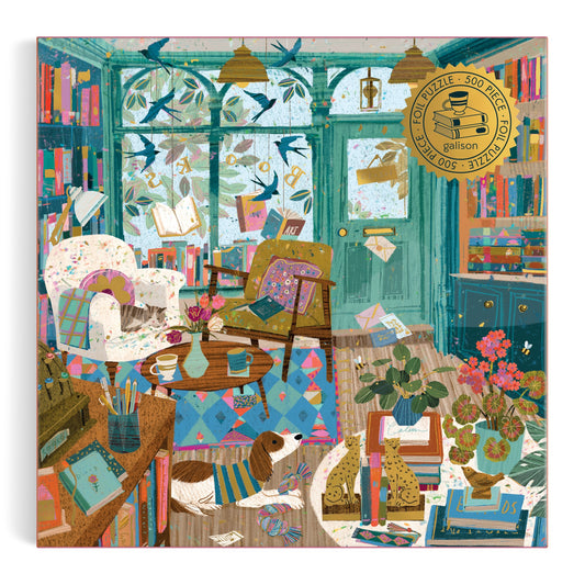 Step into the warmth of a cozy reading room with books, armchairs, and a playful pup—brought to life in Victoria Balls Bookshop Afternoon 500 Piece Foil Puzzle. Bright blue walls and a cheerful rug make this puzzle perfect for book lovers.