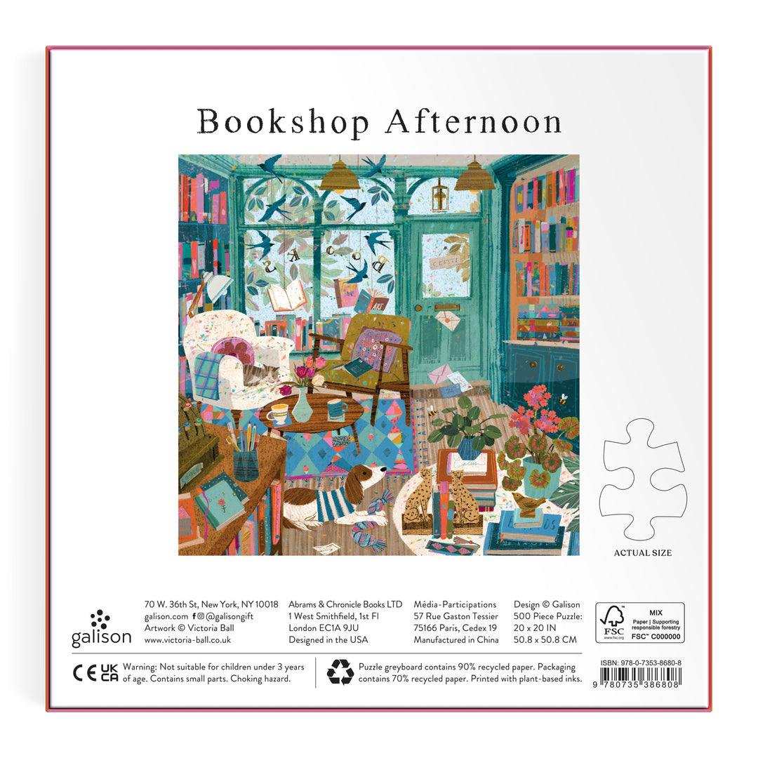 Illustration of a cozy bookshop with colorful books, a cat, and sunlight features on the back of Victoria Ball’s Bookshop Afternoon 500 Piece Foil Puzzle box—inviting you to an afternoon of literary exploration.
