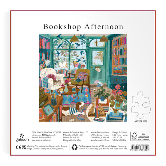 Illustration of a cozy bookshop with colorful books, a cat, and sunlight features on the back of Victoria Ball’s Bookshop Afternoon 500 Piece Foil Puzzle box—inviting you to an afternoon of literary exploration.