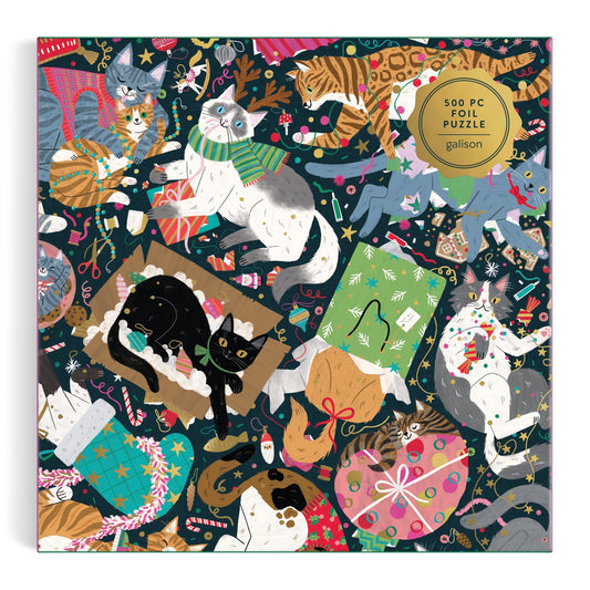 Cheerful cats frolic and lounge among gifts, lights, and ornaments in this festive Maria Kee "Catmas Chaos 500 Piece Foil Puzzle," featuring vibrant holiday scenes and a special foil finish—perfect for cat lovers and puzzle fans alike.