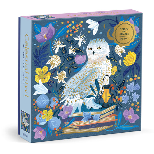 A premium foil puzzle by Dawn Cooper, the Celestial Owl 500 Piece Puzzle features an illustrated white owl with colorful flowers, books, and a lantern on a blue background.