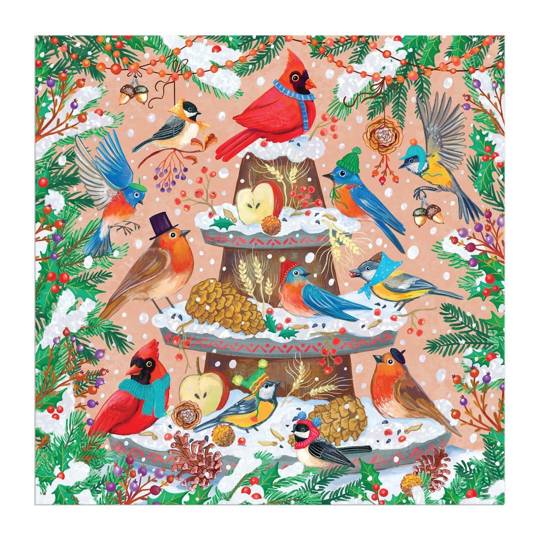 Charming avian illustrations by Olga Akbarova depict colorful, hat-wearing birds around a snowy fountain with pine branches and berries in the Festive Feathers 500 Piece Foil Puzzle.