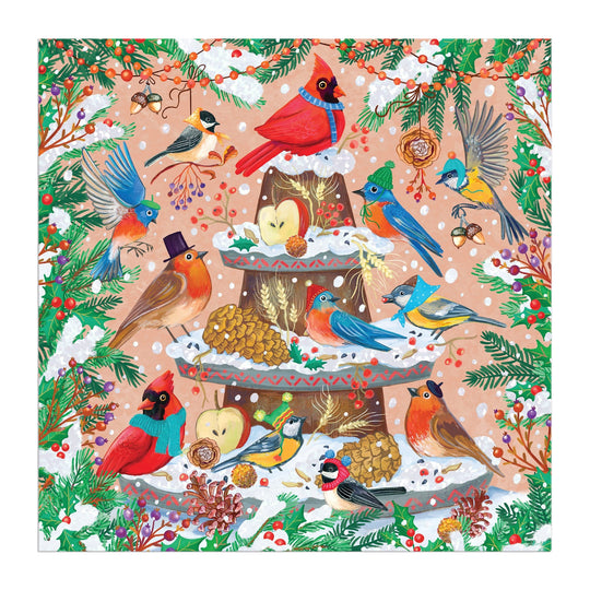 Charming avian illustrations by Olga Akbarova depict colorful, hat-wearing birds around a snowy fountain with pine branches and berries in the Festive Feathers 500 Piece Foil Puzzle.