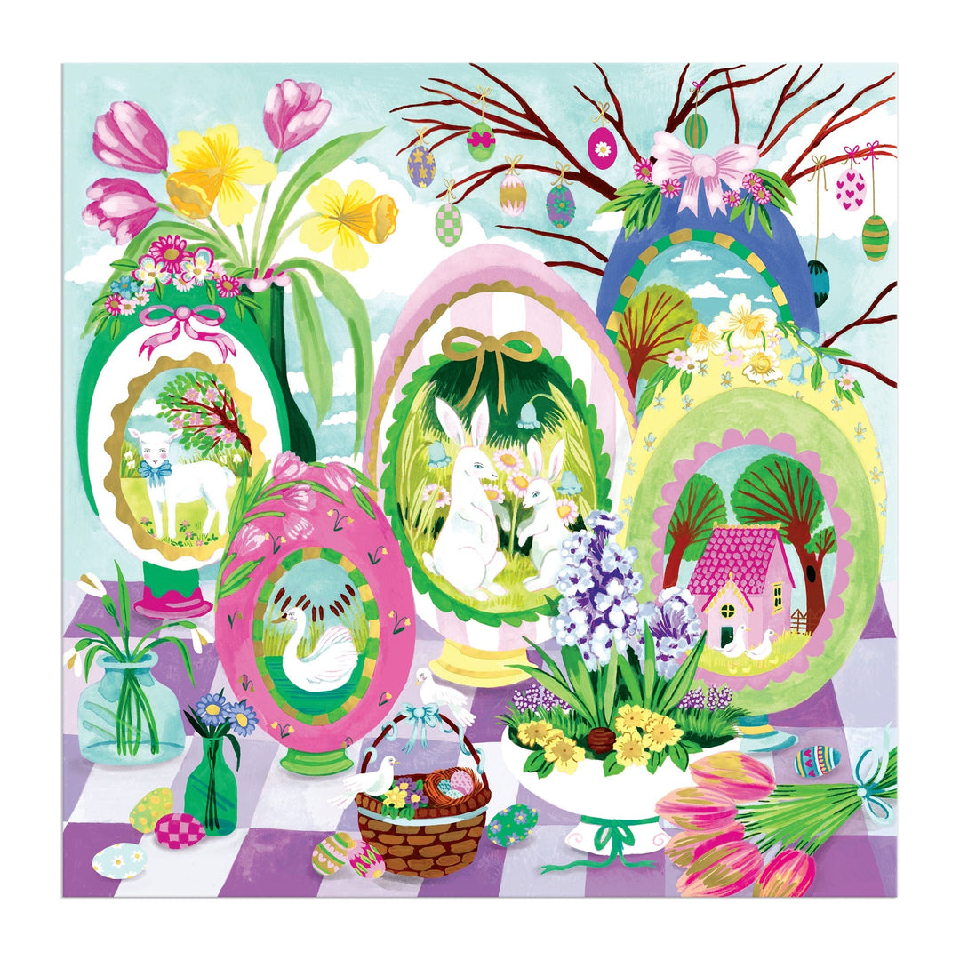 The Windows to Spring 500 Foil Piece Puzzle by Joanna Clay features vibrant Easter eggs with animal and house scenes, surrounded by spring flowers, greenery, and a basket of eggs atop a checkered table with hanging ornaments.