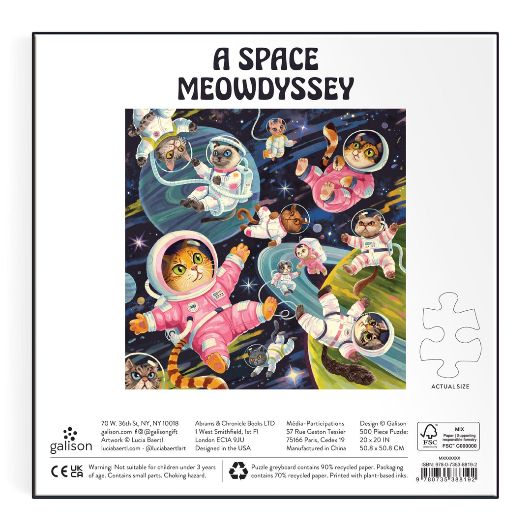 Cats in vibrant space suits float among planets and stars with "A Space Meowdyssey 500 Piece Puzzle" by Lucia Baertl above. Playful cat astronauts star in this colorful puzzle, with piece count and details at the bottom.