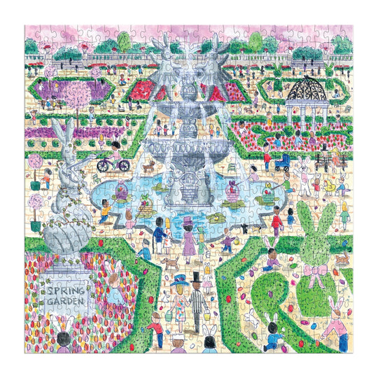 The Michael Storrings Spring Egg Hunt 500 Piece Puzzle by Michael Storrings features a vibrant spring garden with a fountain, people, benches, flower beds, lush greenery, a "Spring Garden" statue, and a gazebo in the background.