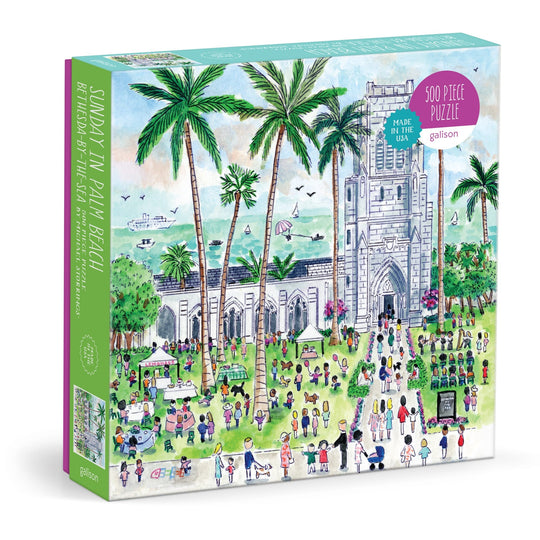 The Michael Storrings Sunday in Palm Beach Bethesda by the Sea 500 Piece Puzzle features a vibrant scene of people on a sunny lawn with palm trees, an ocean view, and a church-like building. Brand: Michael Storrings.