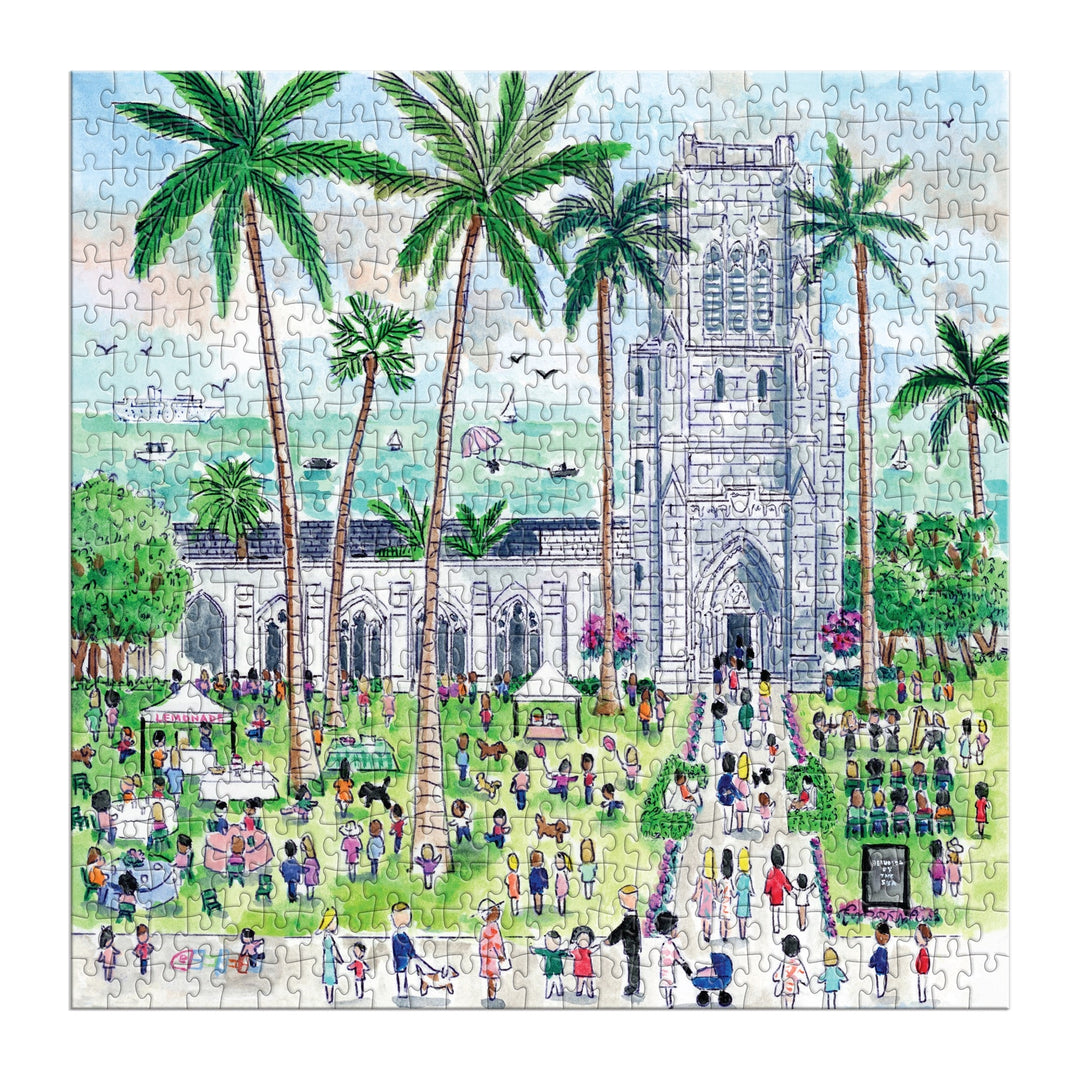 The Michael Storrings Sunday in Palm Beach 500 Piece Puzzle features a vibrant garden scene with people near a stone church, palm trees, market stalls, musicians, and lush greenery under a bright blue sky.