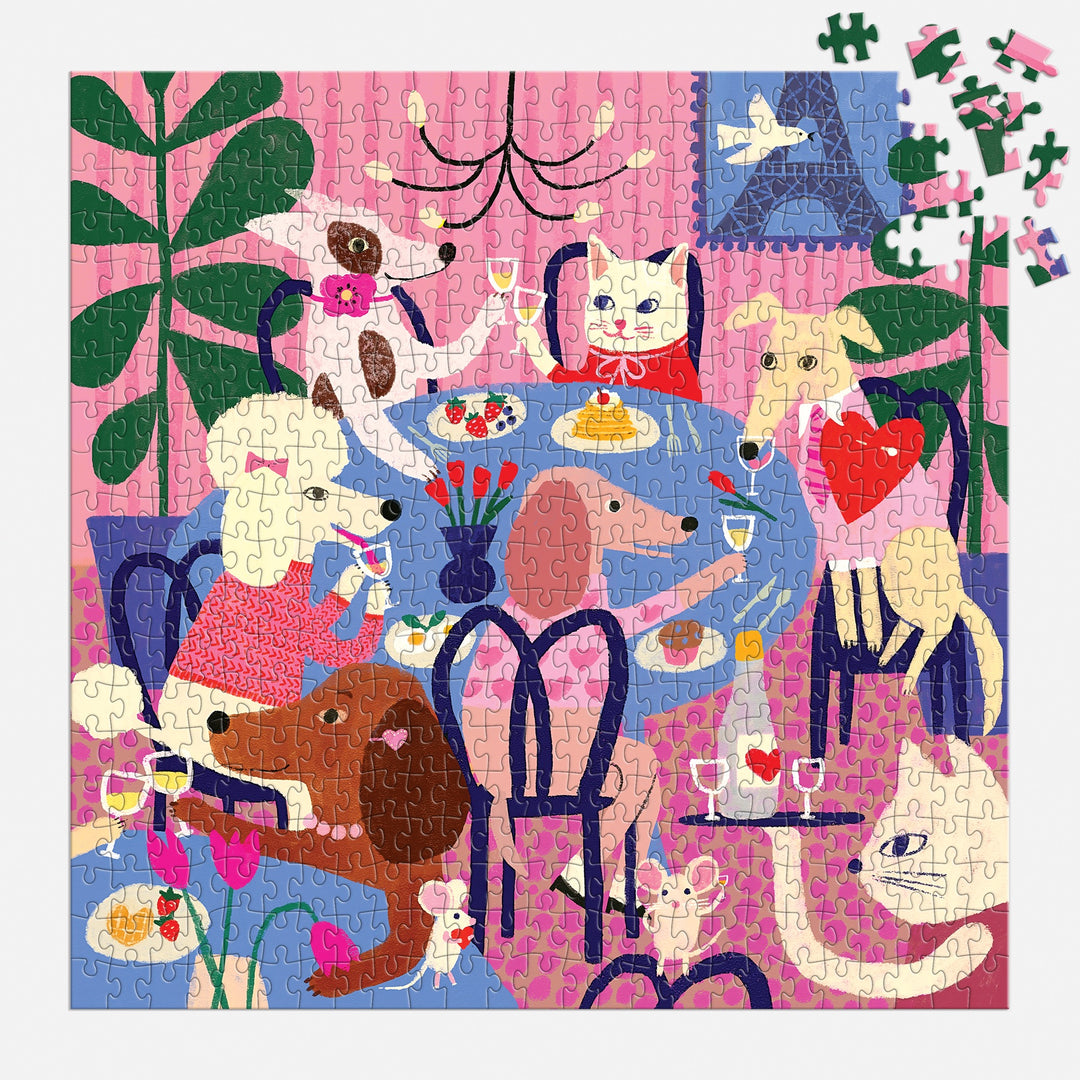 The Paws for Love 500 Piece Puzzle by Anne Bentley features six dogs enjoying food and drinks in a cozy pink room with plants. Some pieces are missing in the upper right corner.