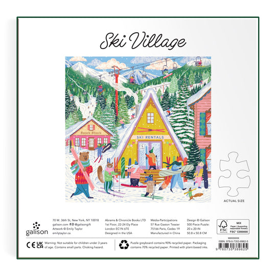 Emily Taylor's Ski Village 500 Piece Puzzle features a lively winter scene with people in ski gear near a yellow Ski Rentals cabin, set among snow, pine trees, and mountains.