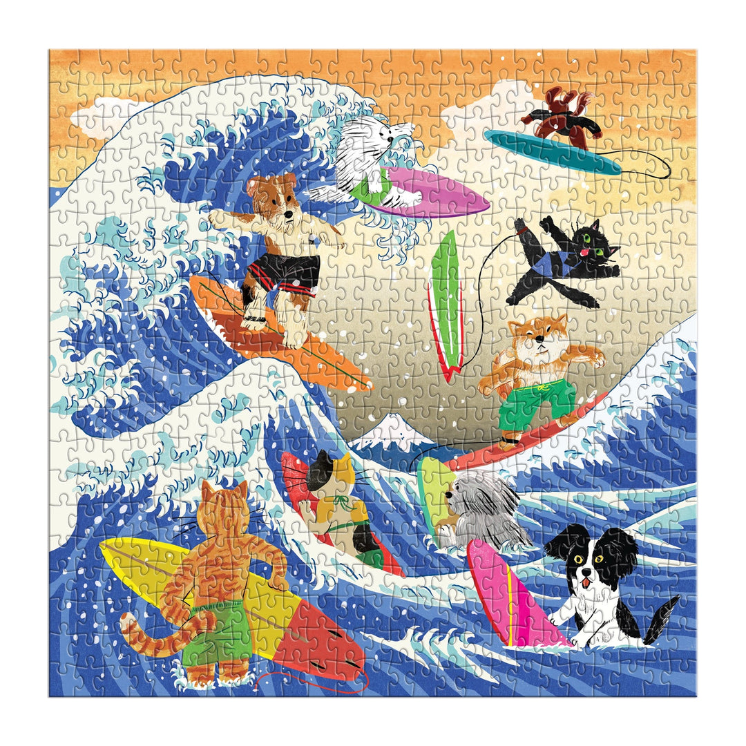 The Great Surf 500 Piece Puzzle by Yeji Yun features playful cats and dogs riding vibrant surfboards on dramatic, curling waves against a bright sky, capturing their adventurous spirit in a stylized ocean scene.