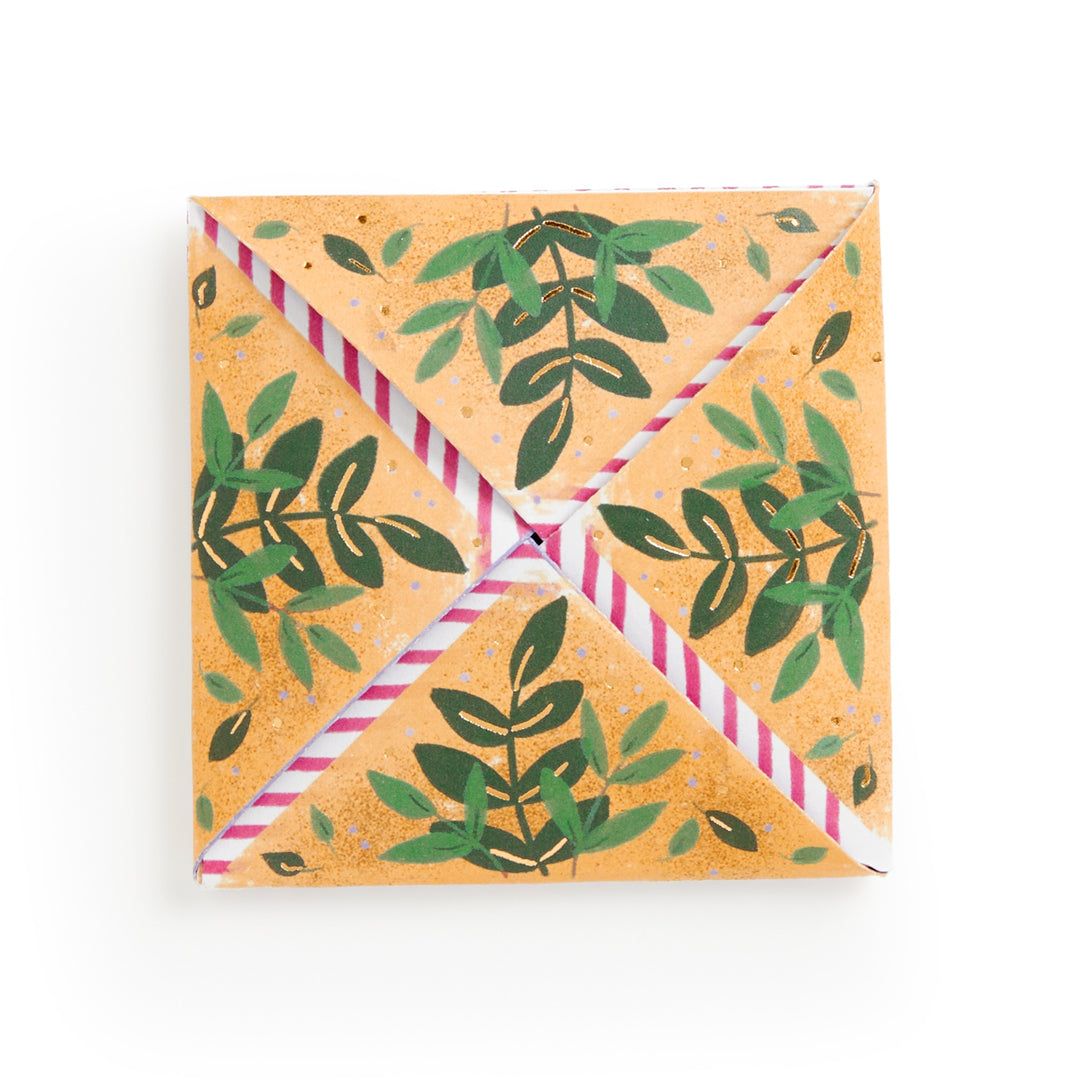 The Joy Laforme Charm Cards by Joy Laforme are square envelopes crafted from orange paper with a green leafy pattern and pink-striped edges, folded with corners meeting at the center—a refined choice for sophisticated correspondence.