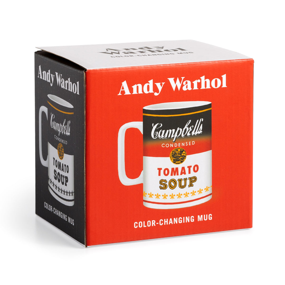 An Andy Warhol red and white box displays the Andy Warhol Soup Can Color Changing Ceramic Mug, featuring the iconic Campbell’s Condensed Tomato Soup design shown from two angles on the packaging.