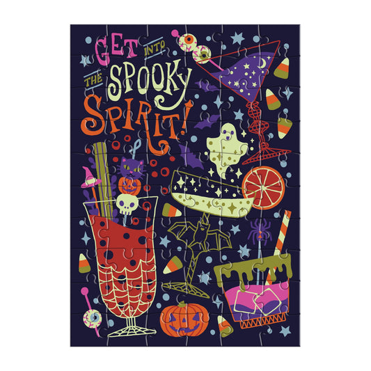 The Camille Chew Get into the Spooky Spirit Greeting Card Puzzle features cocktails, candy corn, a ghost, bats, and eyeballs with bold playful text on a dark background—perfect for Halloween.