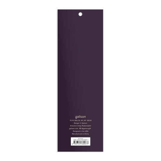 The back cover of a rectangular, vertical Cottage Cats Magnetic Bookmarks by Anja Riebensahm is dark purple with white text detailing the company’s address, design, manufacturing info, and website at the bottom.