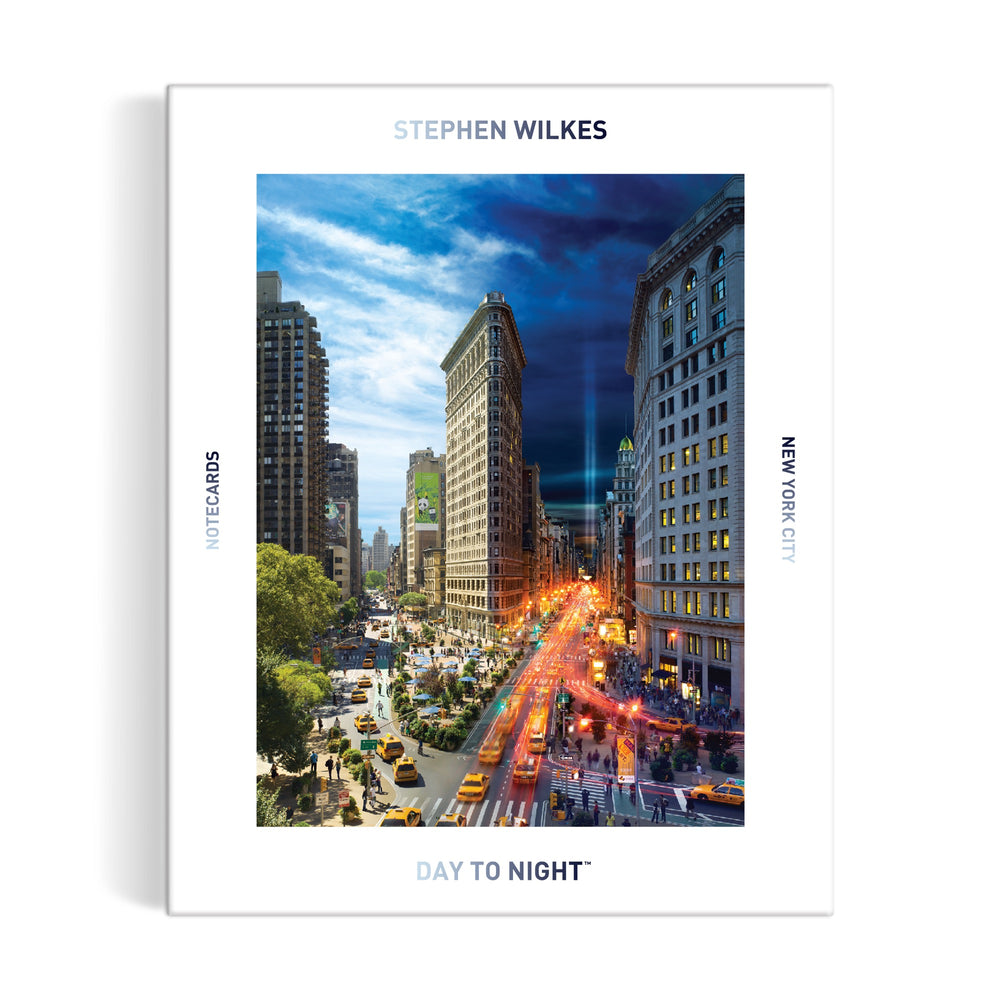 The Stephen Wilkes Day To Night® New York City Notecard Set by Stephen Wilkes Photography, Inc. features a cover of the Flatiron Building transitioning from day to night with vivid yellow taxis and city lights beneath the title.