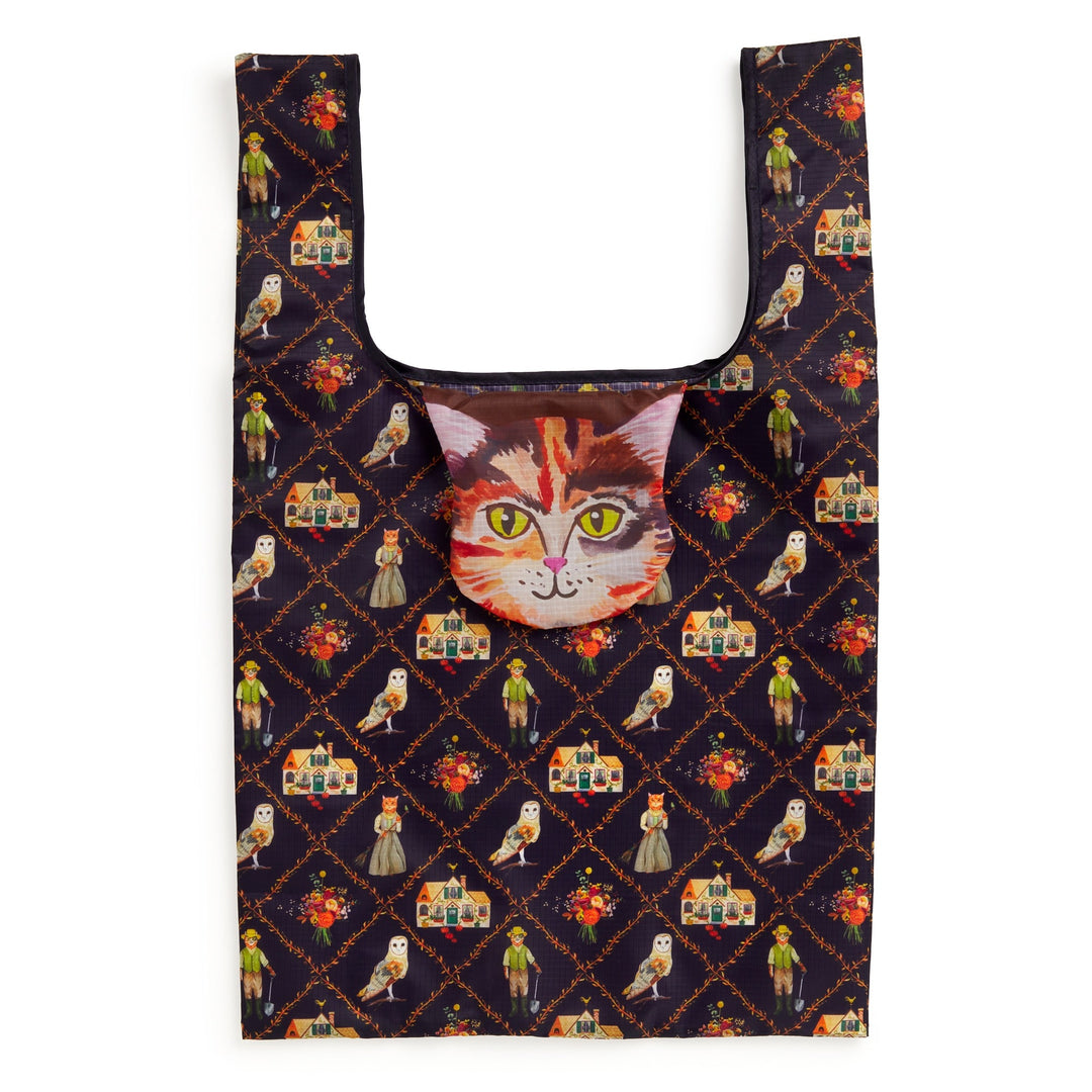 The Cottage Cats Packable Nylon Tote by Anja Riebensahm features a vibrant design of birds, flowers, and people on a dark background, plus a cat face pouch attached at the top center.