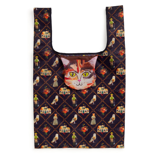 The Cottage Cats Packable Nylon Tote by Anja Riebensahm features a vibrant design of birds, flowers, and people on a dark background, plus a cat face pouch attached at the top center.