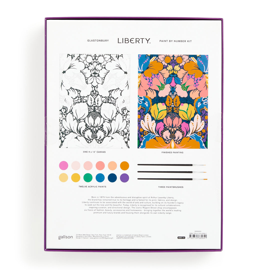 Back of Liberty London’s Liberty 9 x 12 Paint by Number Kit Glastonbury box shows a monochrome floral canvas (left), vibrant completed artwork (right), acrylic paint pots, three brushes, and product details at the bottom.