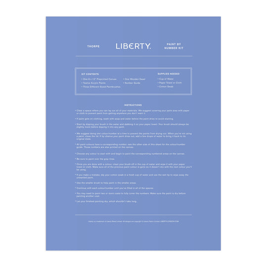 A blue instruction sheet for the Liberty London 9 x 12 Paint by Number Kit Thorpe, featuring white minimalist text listing kit contents, needed supplies, and step-by-step painting instructions, inspired by the Liberty textile archive.