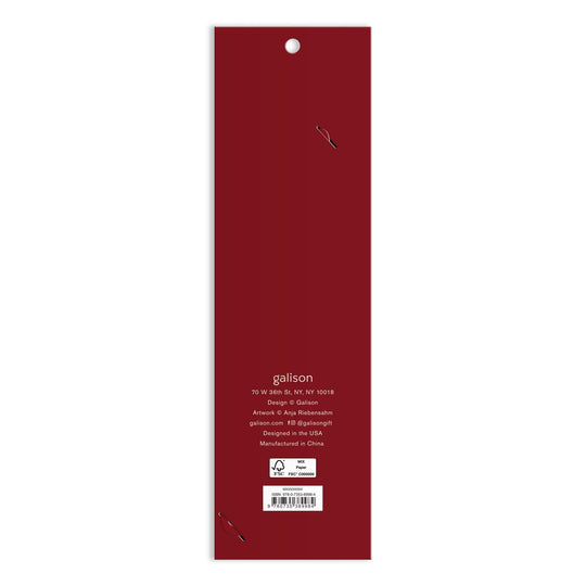 The image shows the back of a tall, rectangular, dark red Cottage Cats Paper Bookmark package by Anja Riebensahm with white text displaying company info, a New York address, manufacturing details, and a small recycling symbol at the bottom.